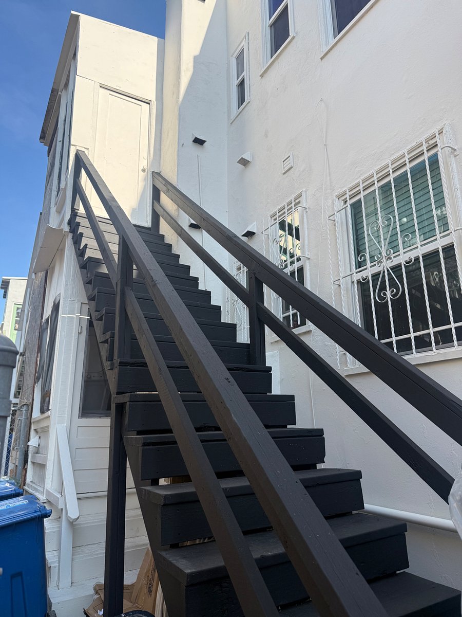 Back of apartment stairs entering into the back area 