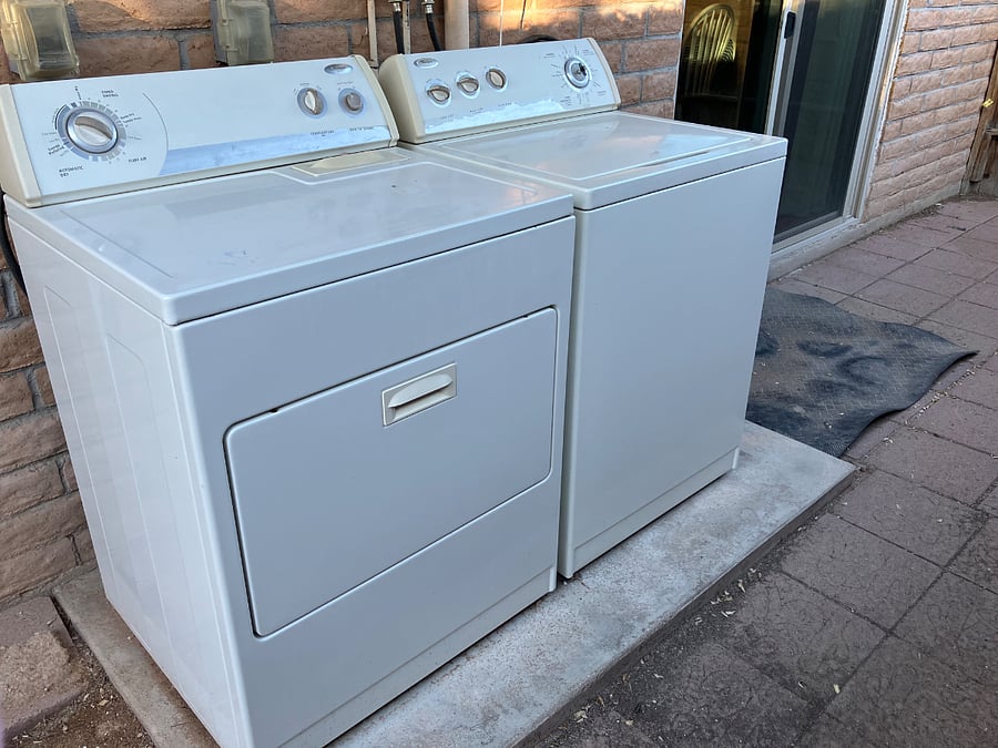 Washer and dryer located on private back patio