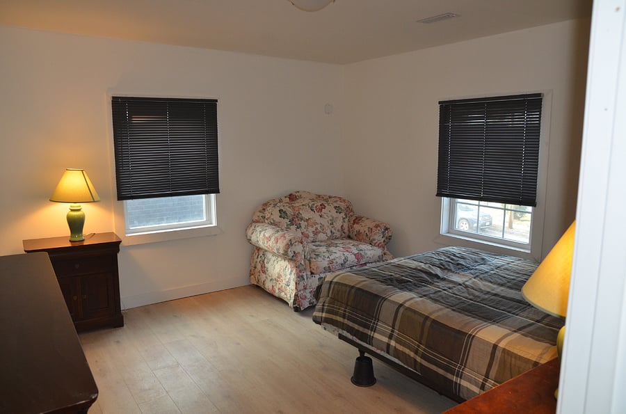 front bedroom with queen bed and couch