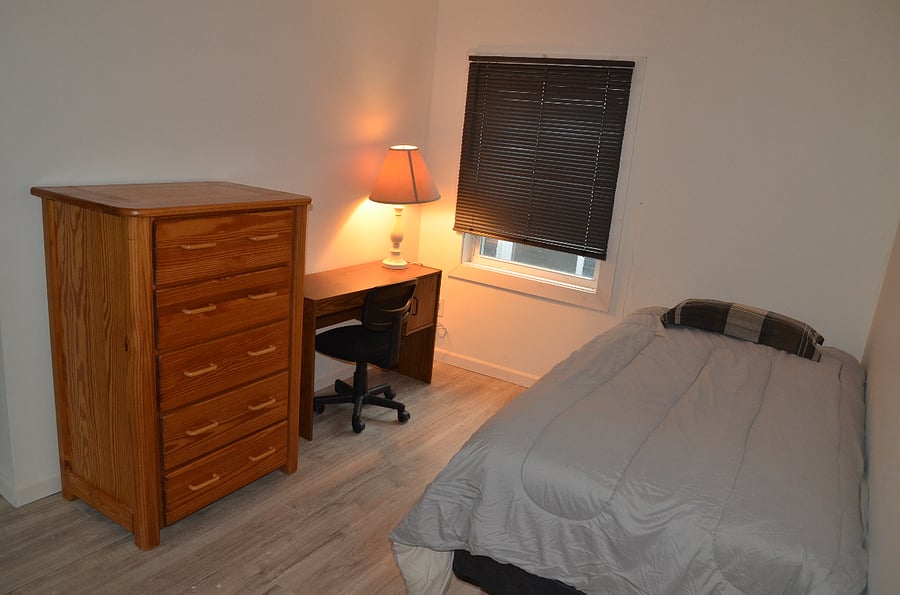 small, cozy bedroom with twin bed and desk