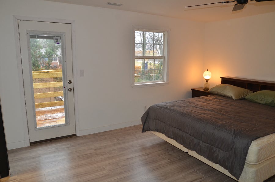 master bedroom with door to large second story outside deck.