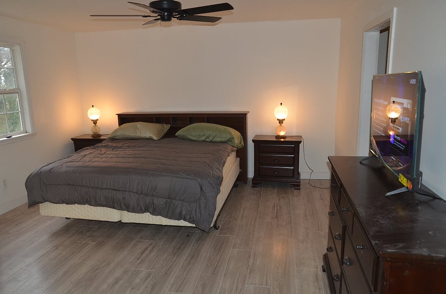 master bedroom with walk-in closet, bath and door to second story deck