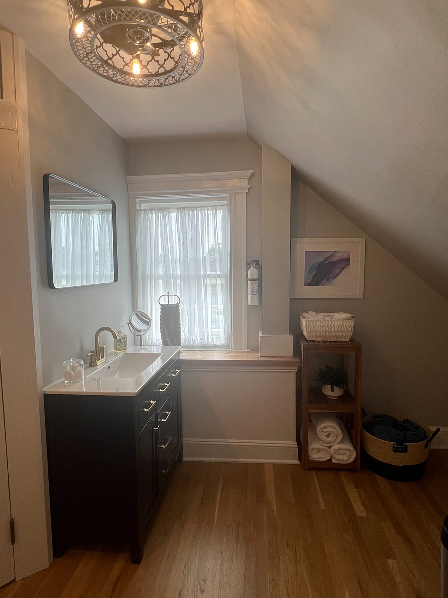 Dressing area with bathroom vanity and storage
