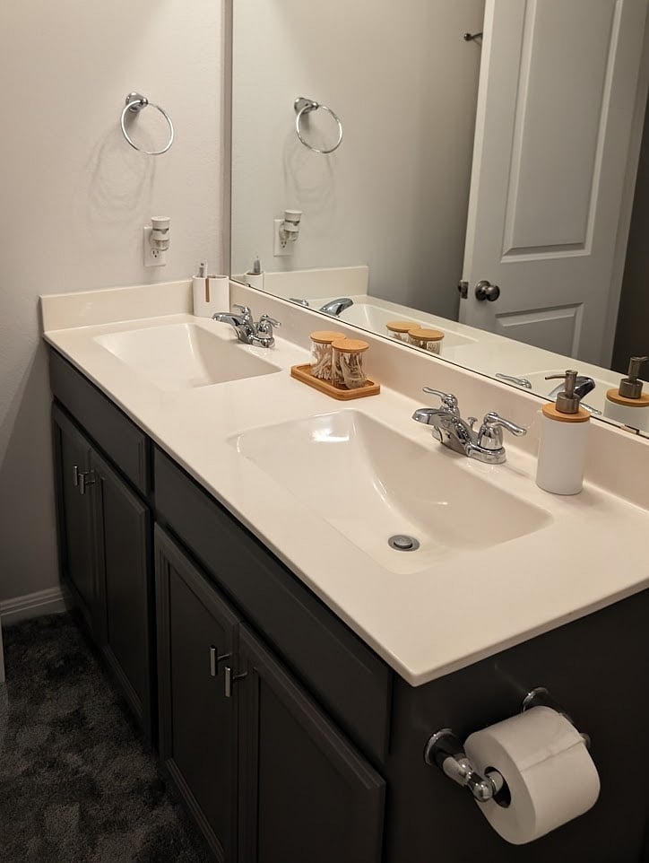 Shared bathroom directly across the hall from the bedroom has dual vanities.