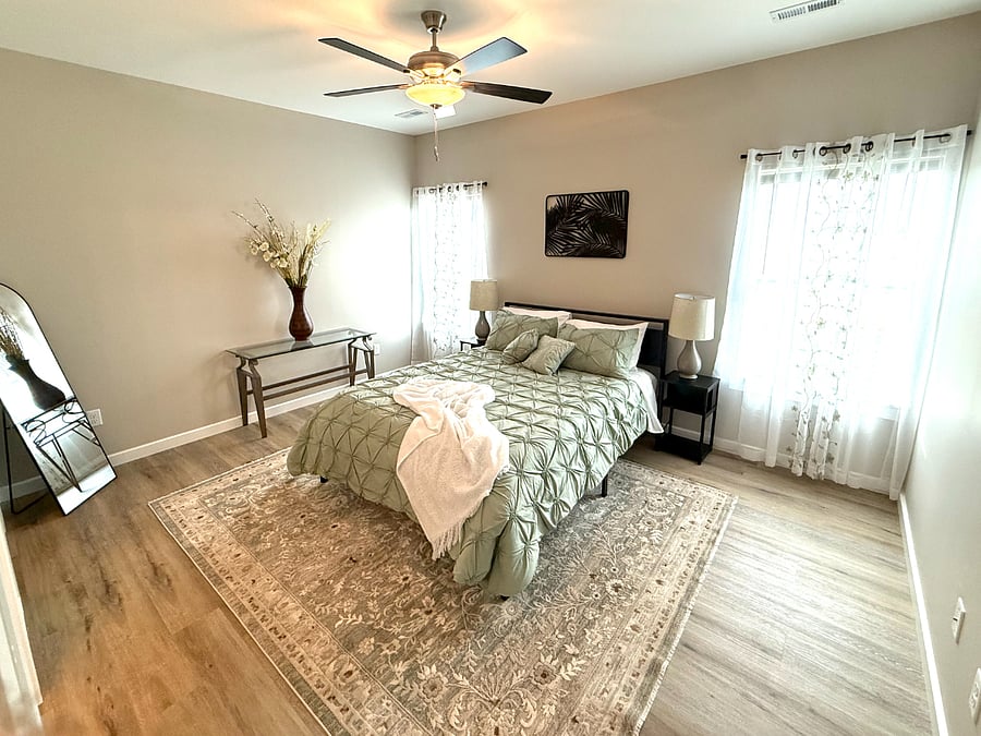 Spacious primary suite with a queen bed, large walk-in closet, dresser, bedside tables with lamps + USB charging ports, and ceiling fan. Super quiet, private, and perfect for resting after a long day!