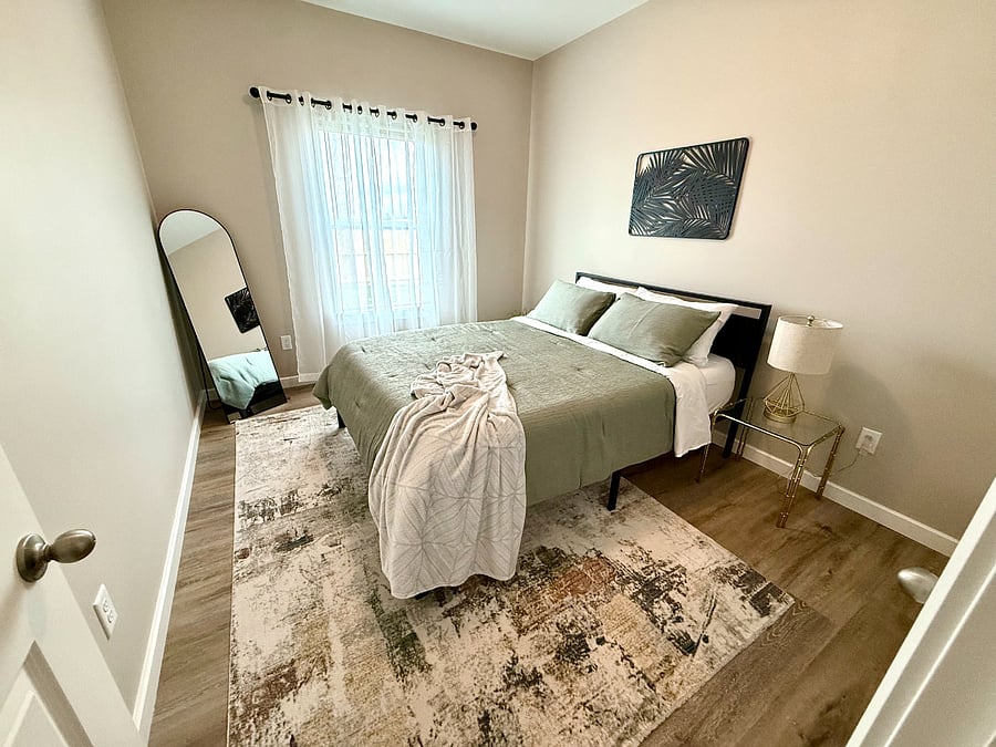 Cozy second bedroom featuring a nice queen bed with comfortable mattress, closet with plenty of hanging space and bedside table with a lamp. Extra blanket provided in the closet for those colder nights. Super quiet and perfect for a good nights sleep.