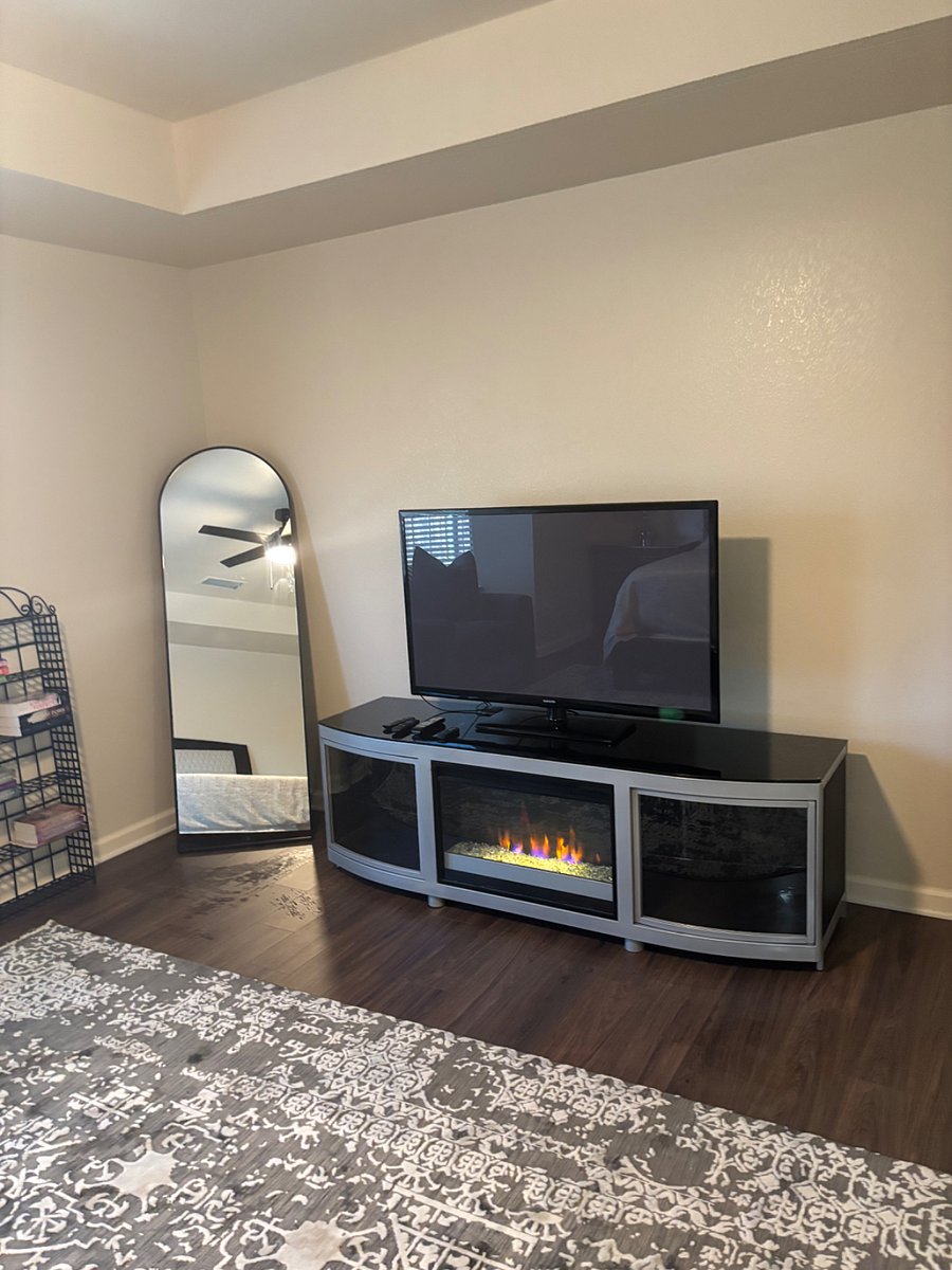 First bedroom full-size floor mirror and fireplace