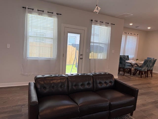 Living room open to kitchen and dining area.