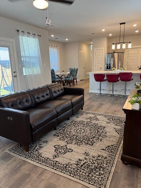 Living room open to the kitchen, breakfast bar, and dining area. 