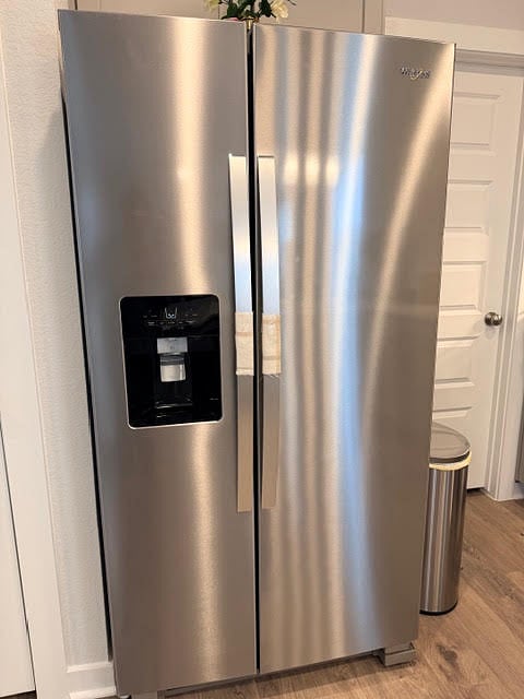 Stainless Steel French door refrigerator with ice and filtered water dispenser. 