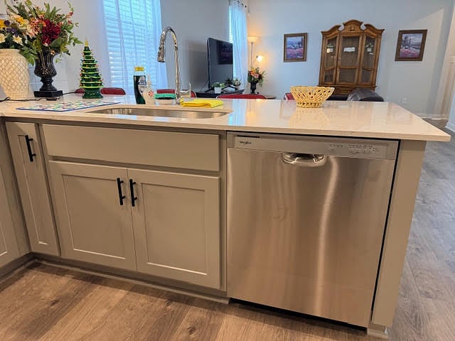 Fully equip shared kitchen area with stainless steel appliances, quartz counter top, subway tile backsplash, and a laundry room by the refrigerator. 