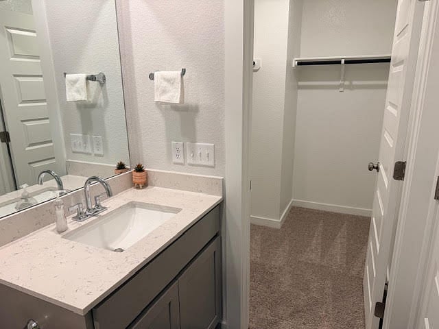 attached private, full bathroom with the ensuite bedroom or 2nd primary bedroom with a bathroom inside the room and a walk-in closet