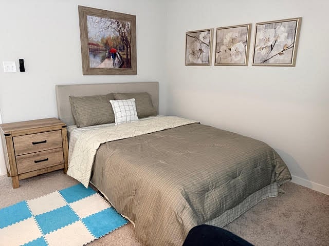 Bedroom with ensuite private, full bathroom or a 2nd primary bedroom fully furnished with ceiling fan with lights, 2" faux blinds and window coverings, carpeted bedroom.