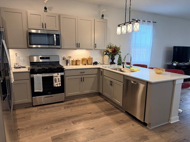 Kitchen area with island breakfast bar, and dining area. The door next to the fridge is the shared laundry room. 