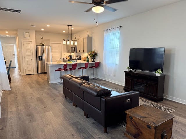 Shared Living room fully furnished and open to kitchen and dining area. Ceiling fan with lights, lots of windows with 2" faux blinds and window coverings.