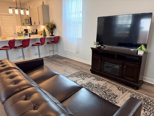 Shared Living room fully furnished and open to kitchen and dining area. Ceiling fan with lights, lots of windows with 2" faux blinds and window coverings.
