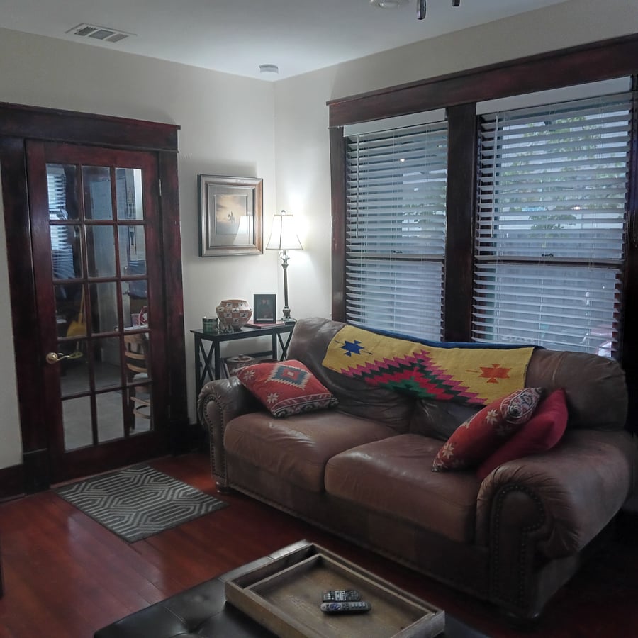 Large comfy leather sofa in living room. Bundle up with blanket. This room has a ceiling fan with remote control and also recessed dimmable lights.