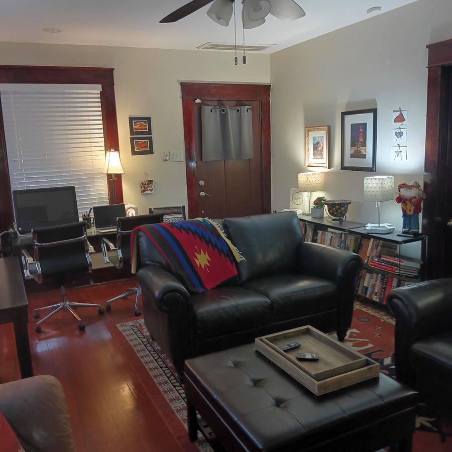 Craftsman style front door. Love seat and recliner create that perfect conversation space. Tabletop lighting throughout set the mood.