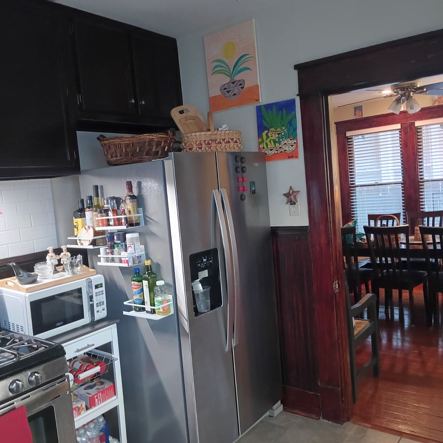 Microwave cart with storage for beverages. Spice racks on refrigerator provide chef convenience.