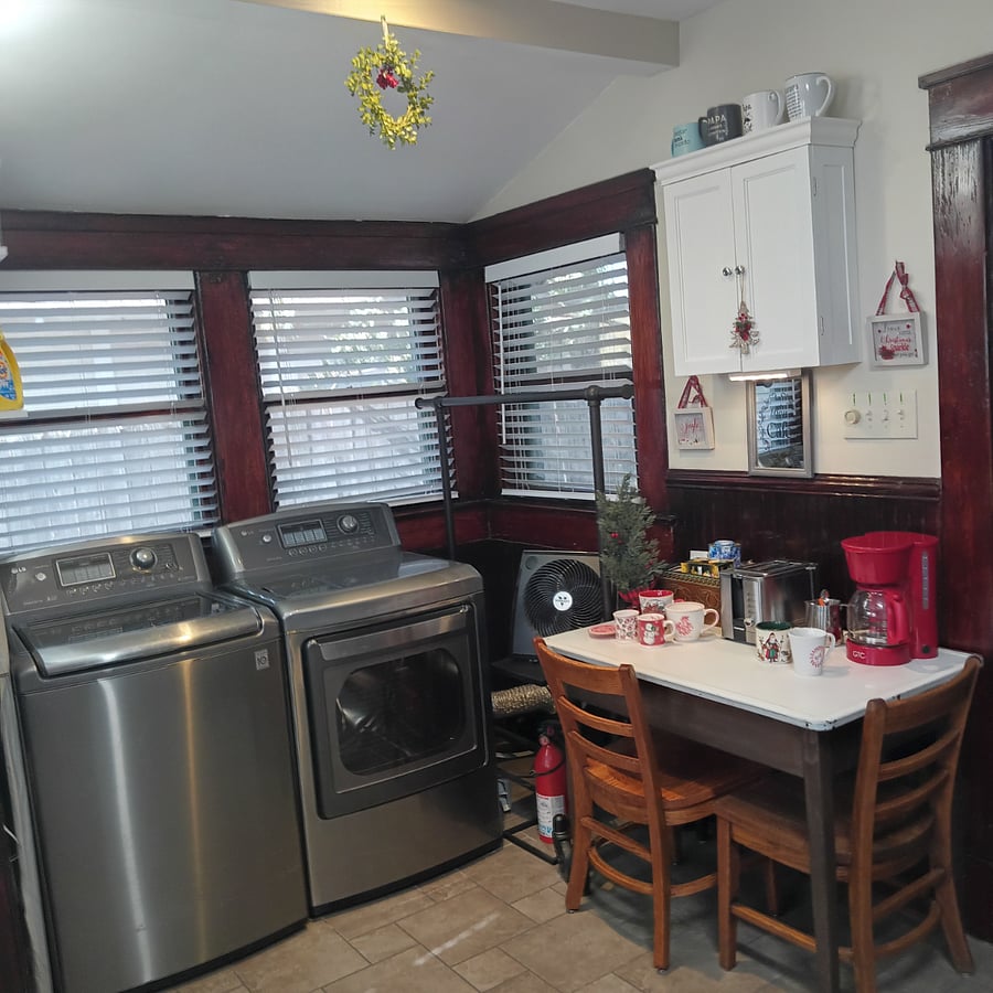 Large-capacity washer and gas dryer. Recessed lighting above laundry space. Coffee bar (vintage table & chairs) with wall cabinet for storage. Under cabinet lighting.