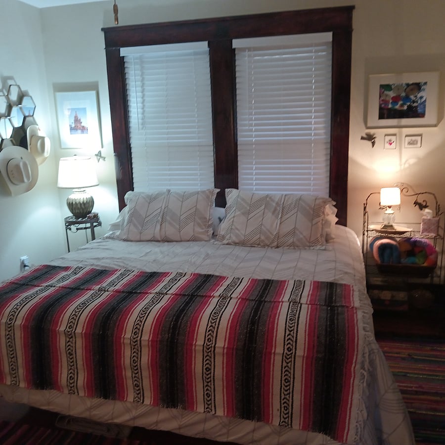 Front guest room has a king-size bed. It has a ceiling fan with remote control.