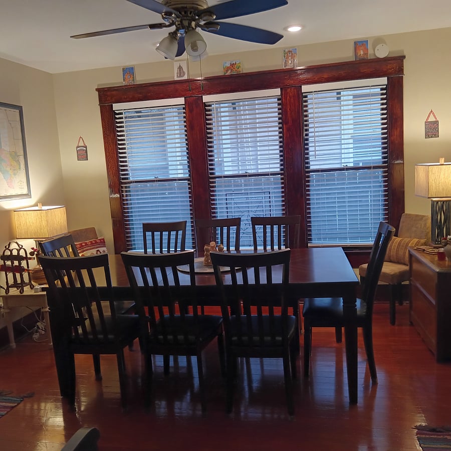 Bank of 3 windows in dining room. Original beautiful wood floor and window woodwork. Dining table seats 8!