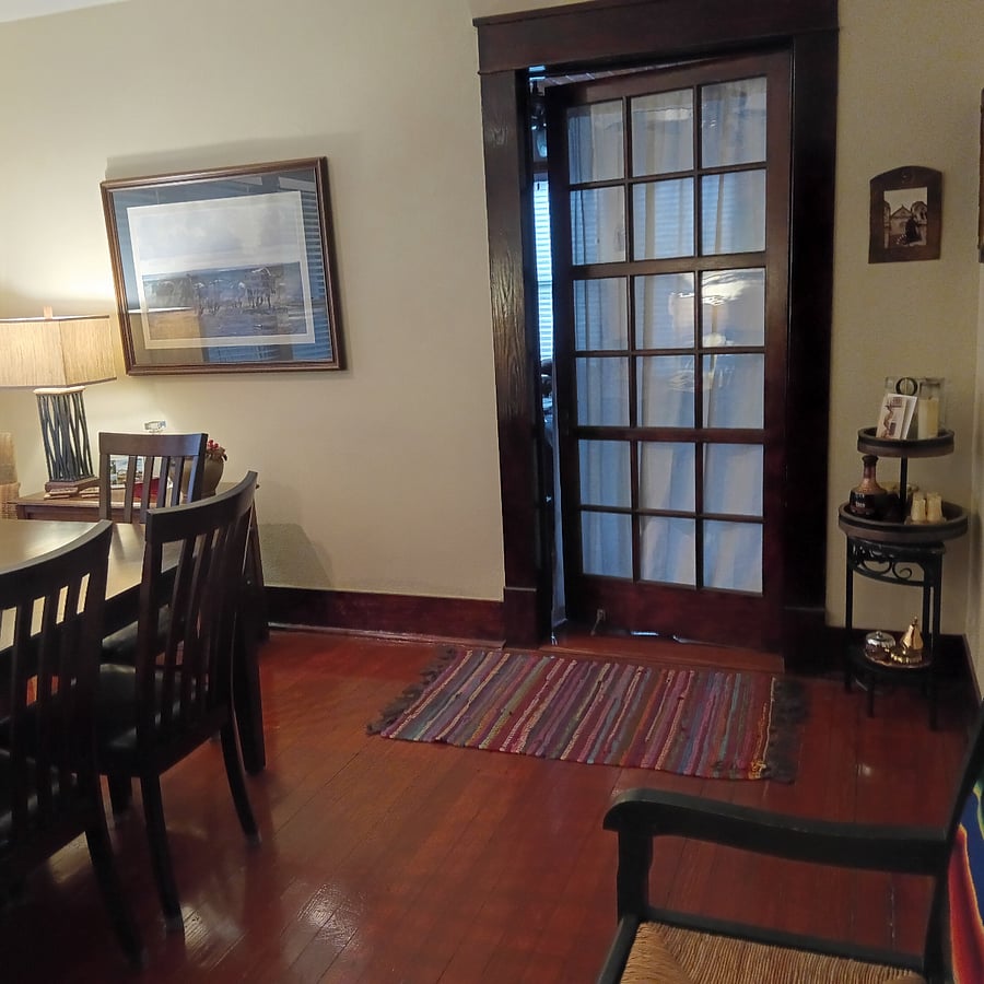 Door from dining room leads into the master bedroom. Original glass pane door.