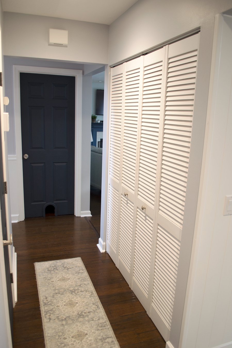 Hallway leading to the basement door, coat closet, half bathroom, and garage entry.