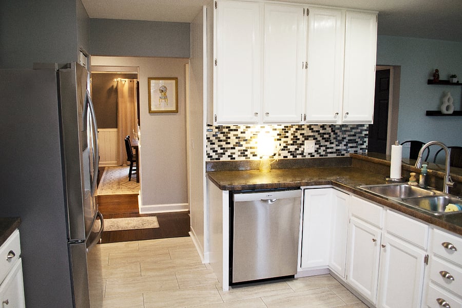 The kitchen comes equipped with dishes and a dishwasher to clean them.