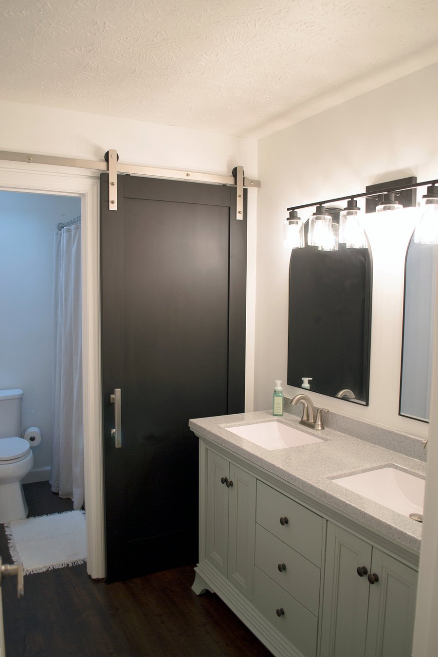 The upstairs hall bathroom has been fully updated with double sinks, shower/tub combo, and a sliding barn door for extra privacy.