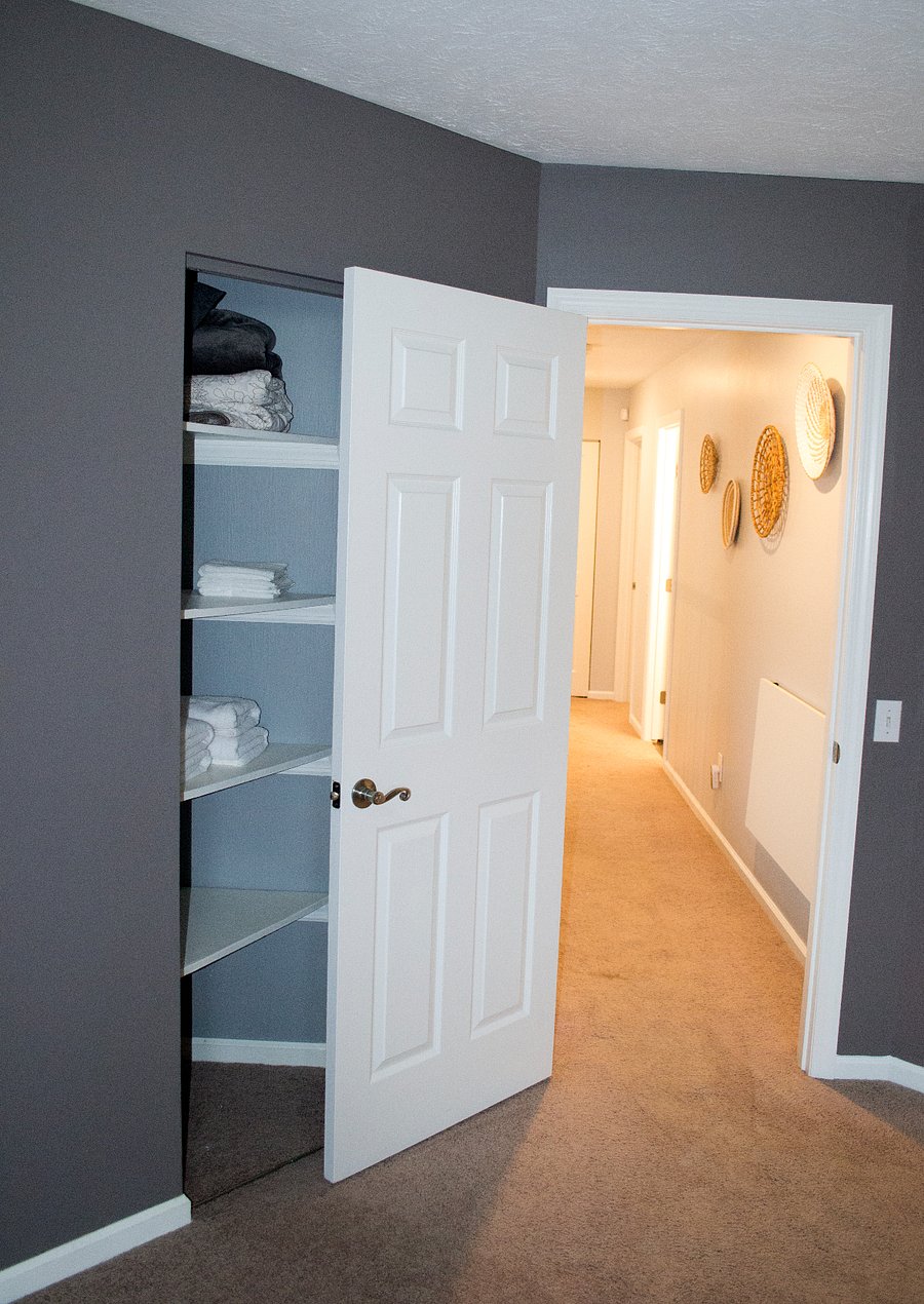 The master bedroom also includes a linen closet stocked with towels, washcloths, and extra bedding.