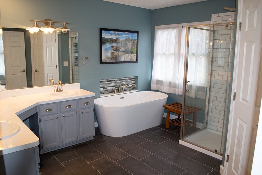 The primary bathroom has been fully updated. The room features double sinks, a large soaking tub, glass shower with rain shower head and other attachments, as well as a separate toilet room. This bathroom overlooks the backyard.