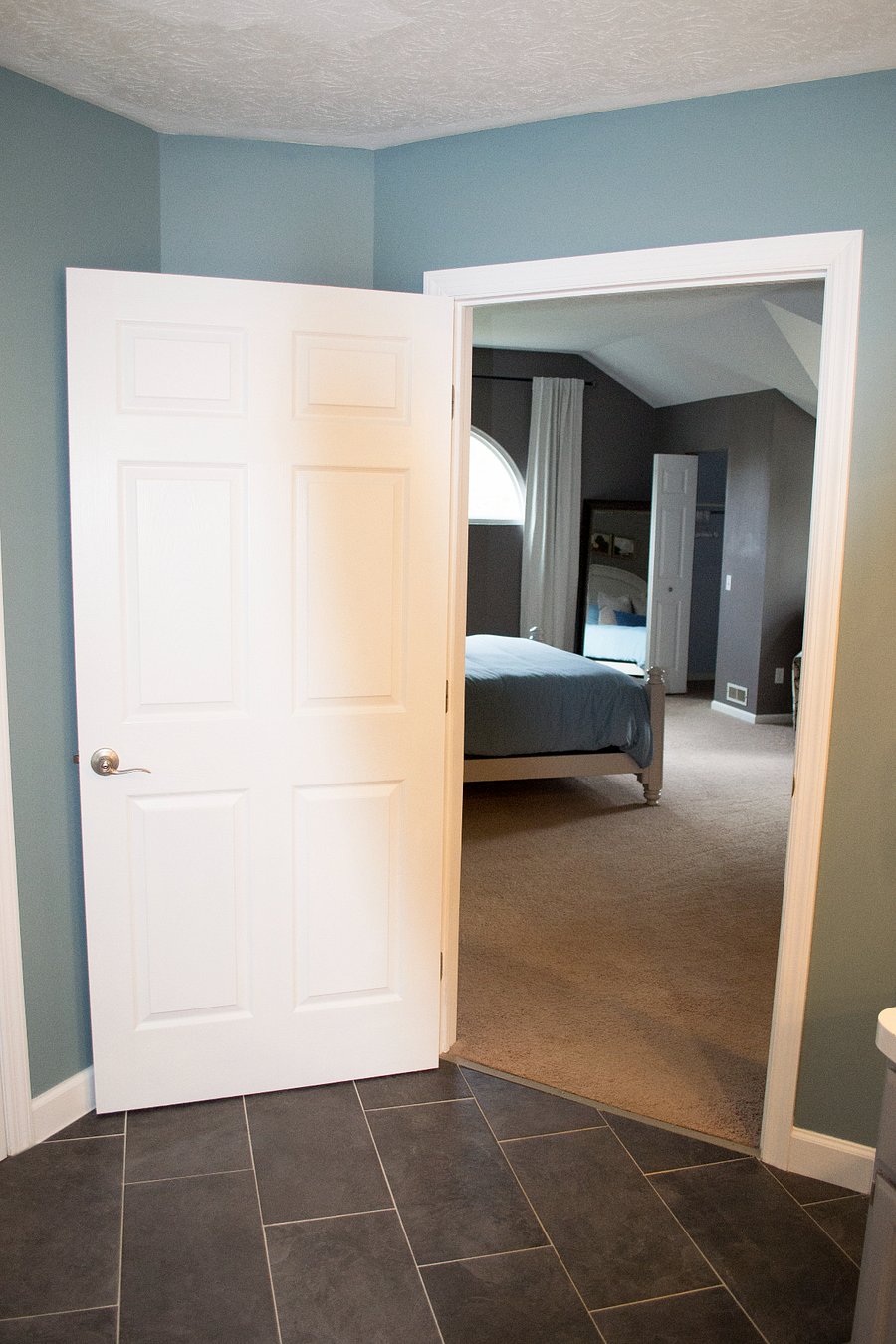 The primary bathroom has a door for privacy.