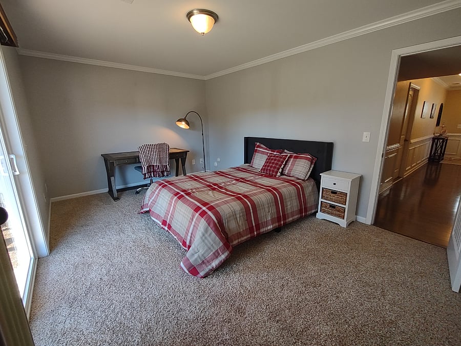 1st floor bedroom with work space and sliding door walk-out
