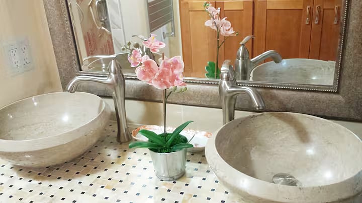 Close-up of bathroom sinks and mirror.