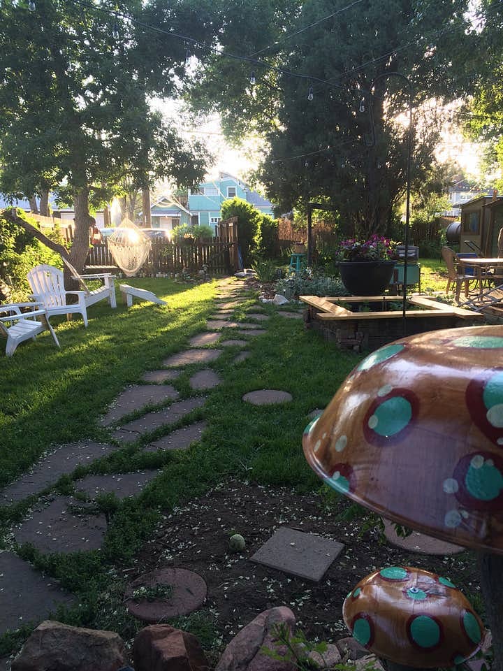Shared back yard with fire pit and sky chair.
