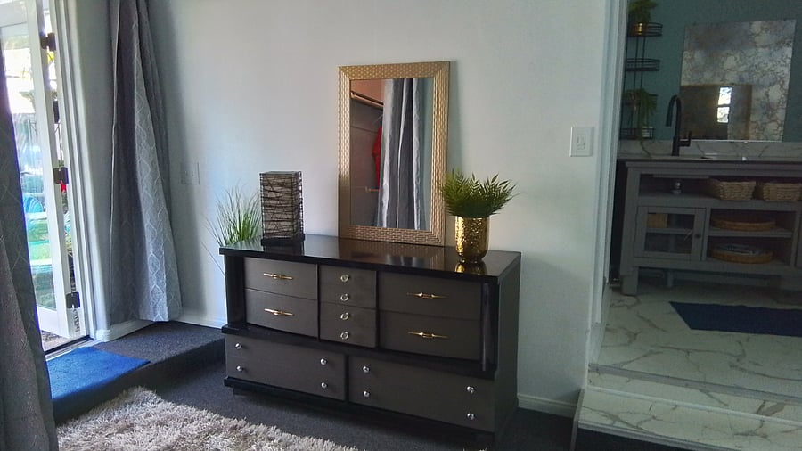 Dresser.  Smart TV goes on this wall.