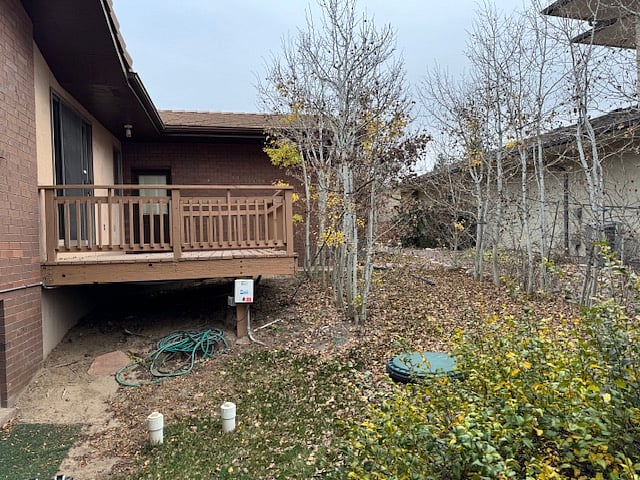 Side of house with another deck and another entrance to laundry room.