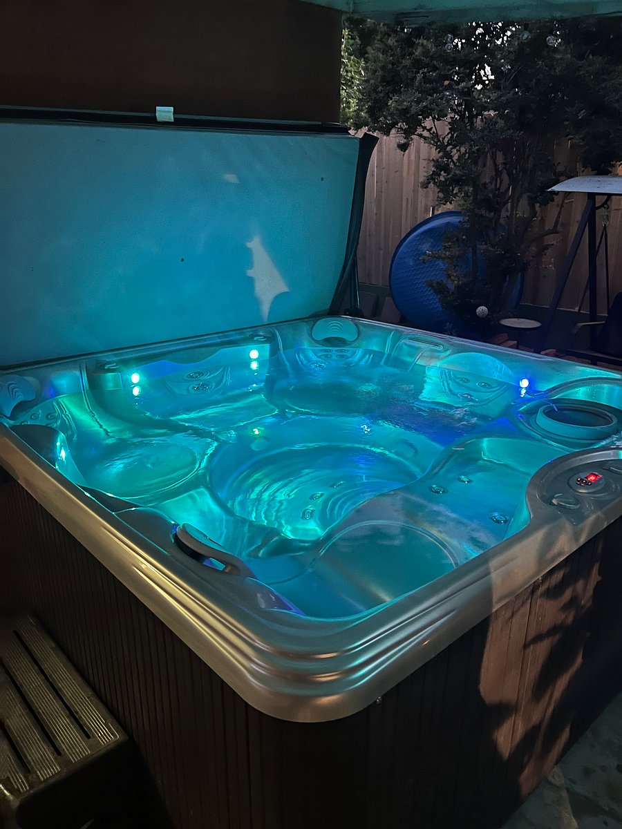 For an added touch of luxury, guests can choose to enjoy access to the beautiful outdoor 7-person hot tub, perfect for relaxing after a long day or enjoying a peaceful evening under the lights.
Hot Tub Features:
Powerful therapeutic jets designed to relieve tension and soothe muscles
Color-changing LED lighting for the perfect nighttime ambiance
Comfortable multi-level seating to accommodate individuals or groups
Private, partially covered patio area for year-round enjoyment
Steps for easy entry and a clean, well-maintained system
Quiet, relaxing space surrounded by greenery and outdoor dcor
Access:
Available as an optional add-on for guests who want a spa-like experience right at home.
Whether youre unwinding solo or inviting a friend over for a peaceful soak, the hot tub adds a luxurious, resort-style touch to your stay.