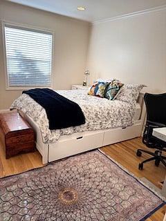 Bedroom 1 with a queen sized bed and TV & Desk with pull out trundles for more storage