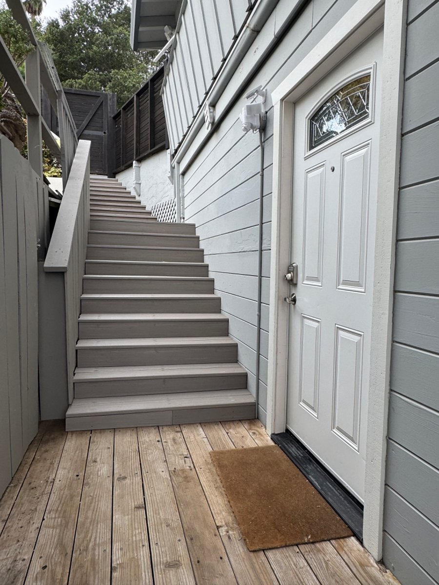 The front door and the stairway leading to it from the gate.