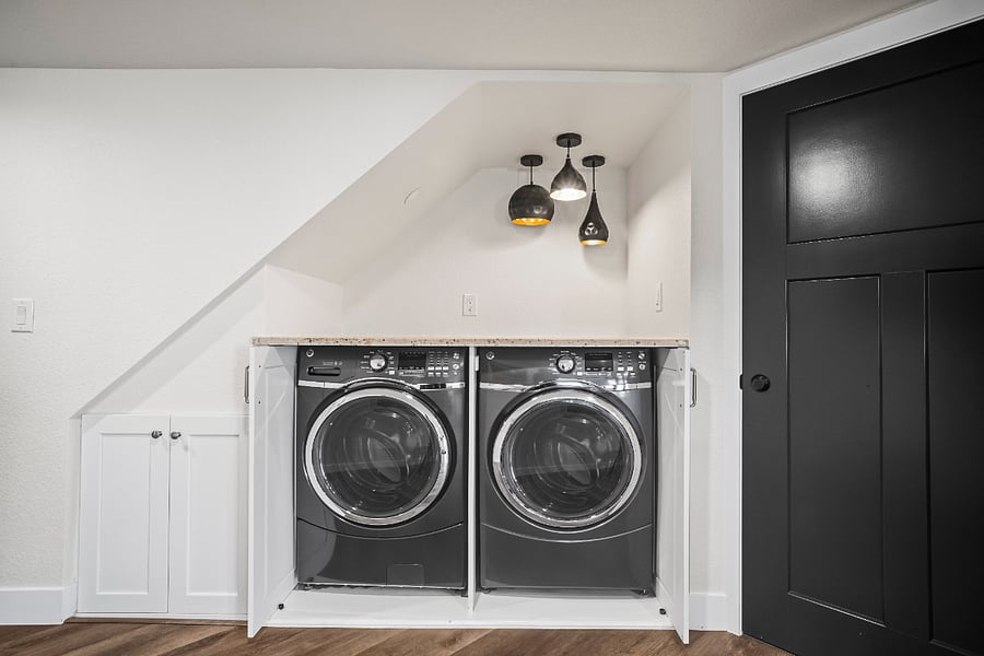 In-unit washer and dryer tucked into custom built-in cabinets that close for a clean, quiet look.