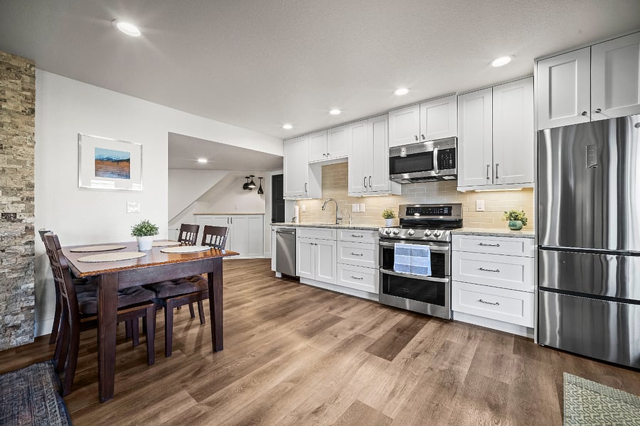 Bright, modern kitchen with stainless appliances, ample storage, and a dining area for comfortable meals at home.