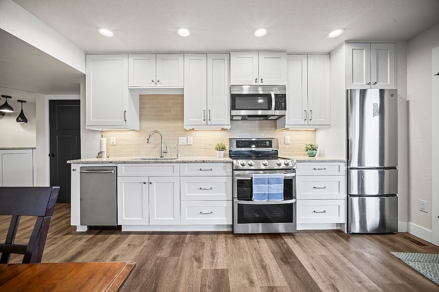 Modern kitchen with stainless appliances, granite counters, filtered instant hot water, and an ice maker.