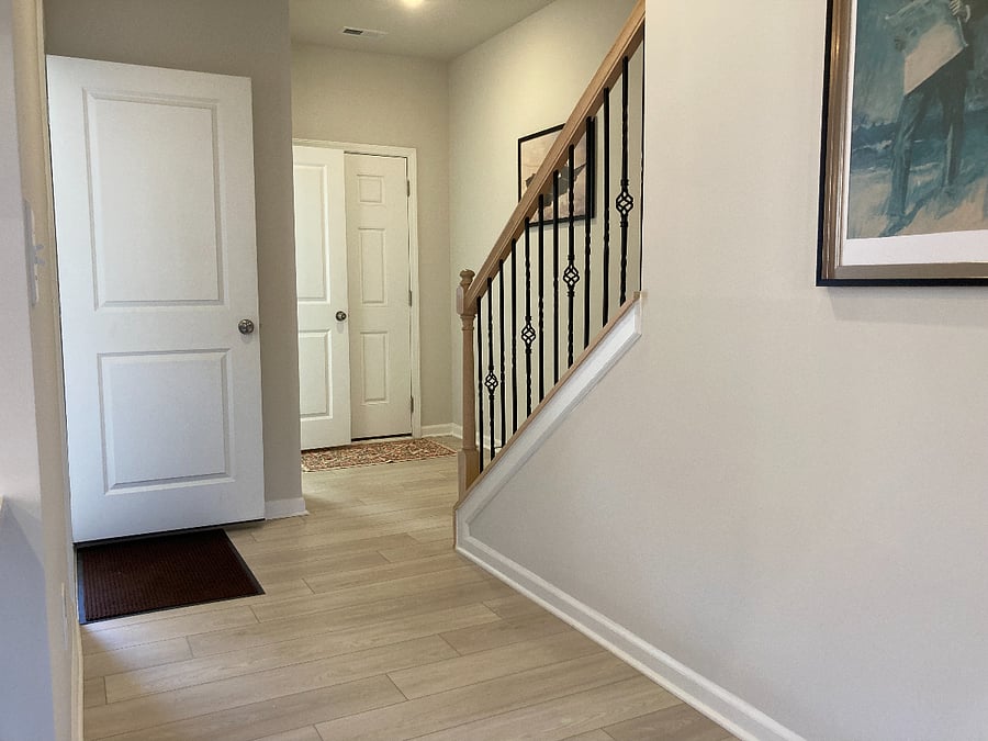 This is the entry area from the front door and the side door which opens up to the attached garage. There is a half-bathroom with toilet and sink directly left of the front door.