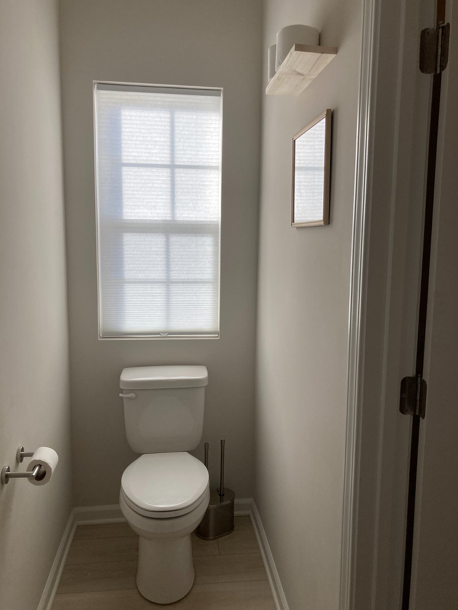 Half-bathroom on the first floor is tucked away.