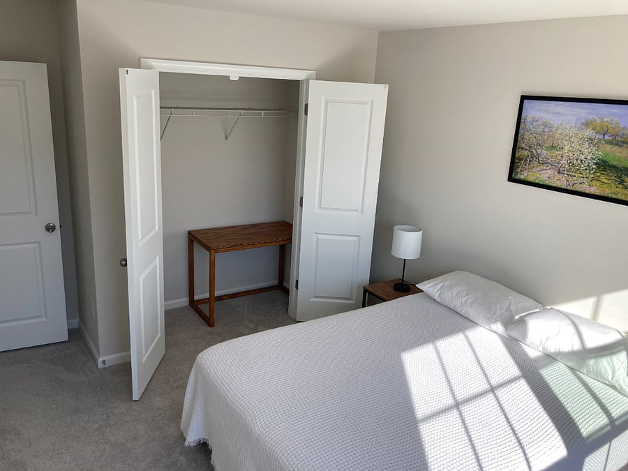 A mini writing desk fits in the closet perfectly when it's not being used.