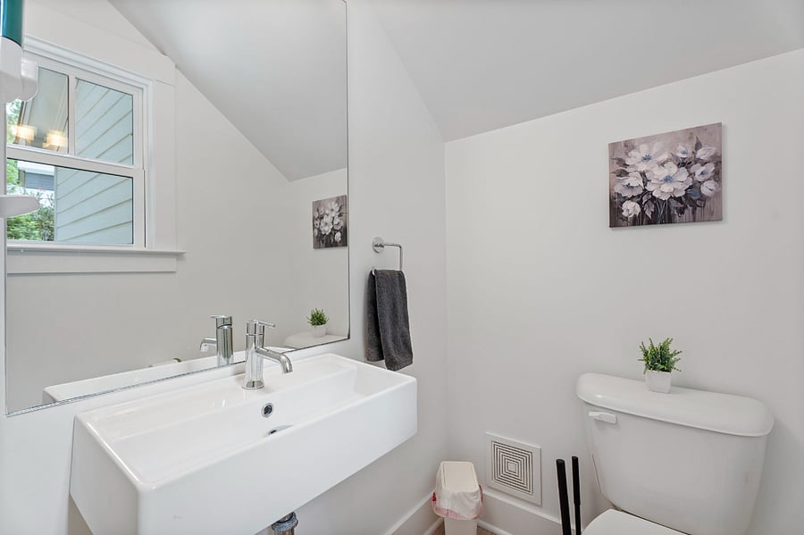 Cute half bath on first floor near back door of the home.