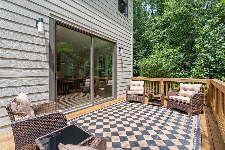 Oversized Sliding doors leads to scenic private deck.