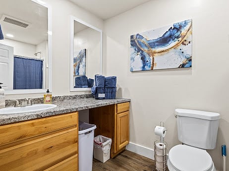 Sink, toilet, vanity and linens in bathroom